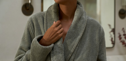 Close up of a person wearing a comfy moss classic bathrobe
