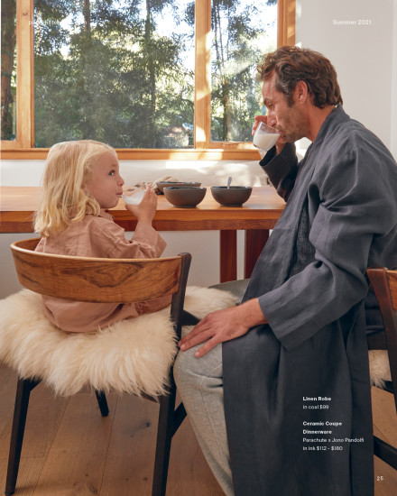 Man sitting in his linen robe at the breakfast table with his son eating breakfast