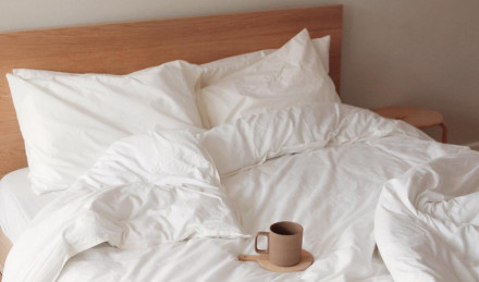Cream Percale bedding with cup of coffee 