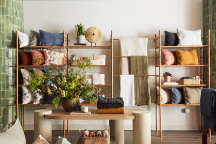 Shelves with neatly hanging and folded pillows and sheets
