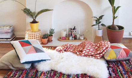 Image of pillows and blankets laid out on the floor. 