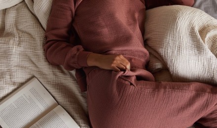 woman in loungewear with book. 