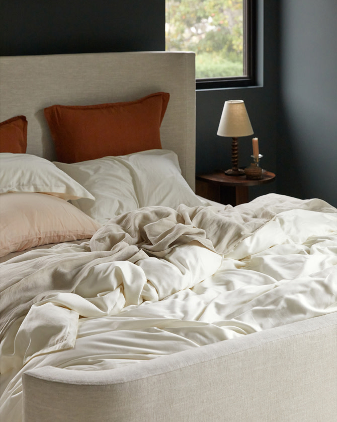 Messy light colored Sateen sheeting on a bed