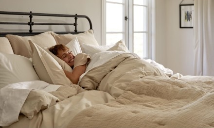 person sleeping with a comforter 