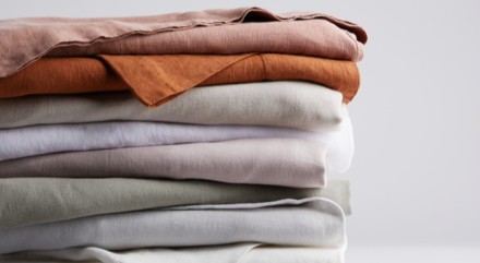 stack of linen sheets in various colors