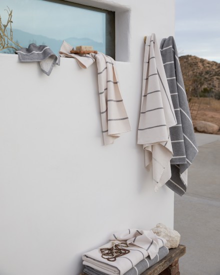Fouta stripe towels hanging by an outdoor shower