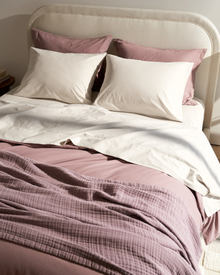 A bed with bone and clover brushed cotton sheets