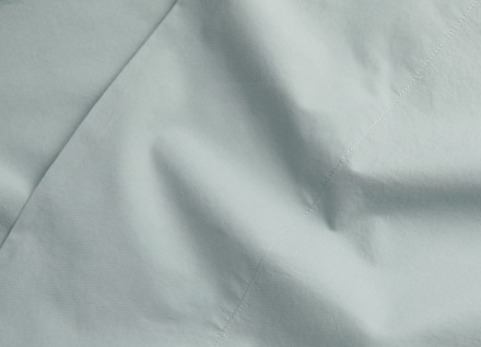 A detail photo of spa-blue cotton percale sheets