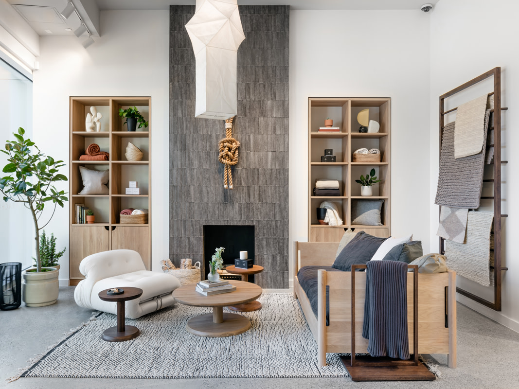 Living room with home items stacked on wall shelving with two couches facing each other