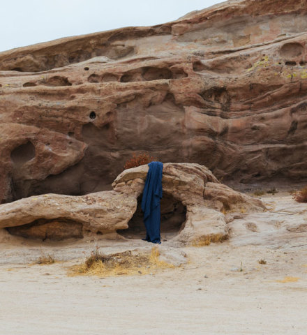 Indigo fabric hanging on a rock in the desert.