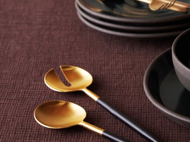 Black And Gold Serving Set Shown In A Room