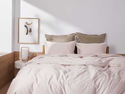 Front view of a clean bed with Blush sheeting