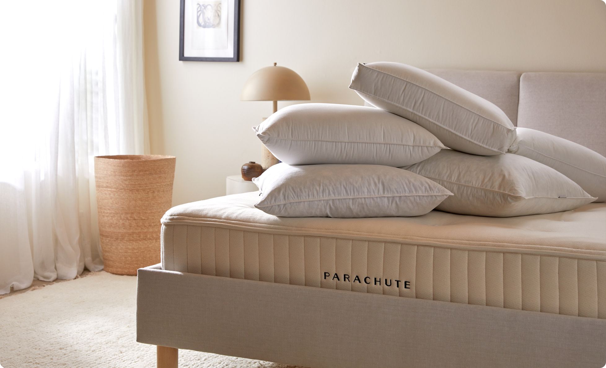 Pillow inserts stacked on a bare mattress