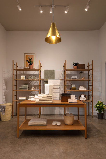 Light wood shelving and table with assorted Parachute towels 