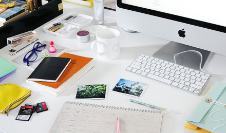 Image of a desk with lots of stuff on it. 