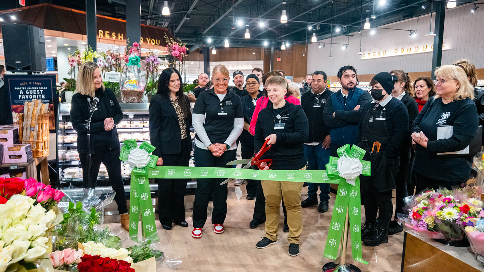 Employees cutting ribbon at Northrbook store opening