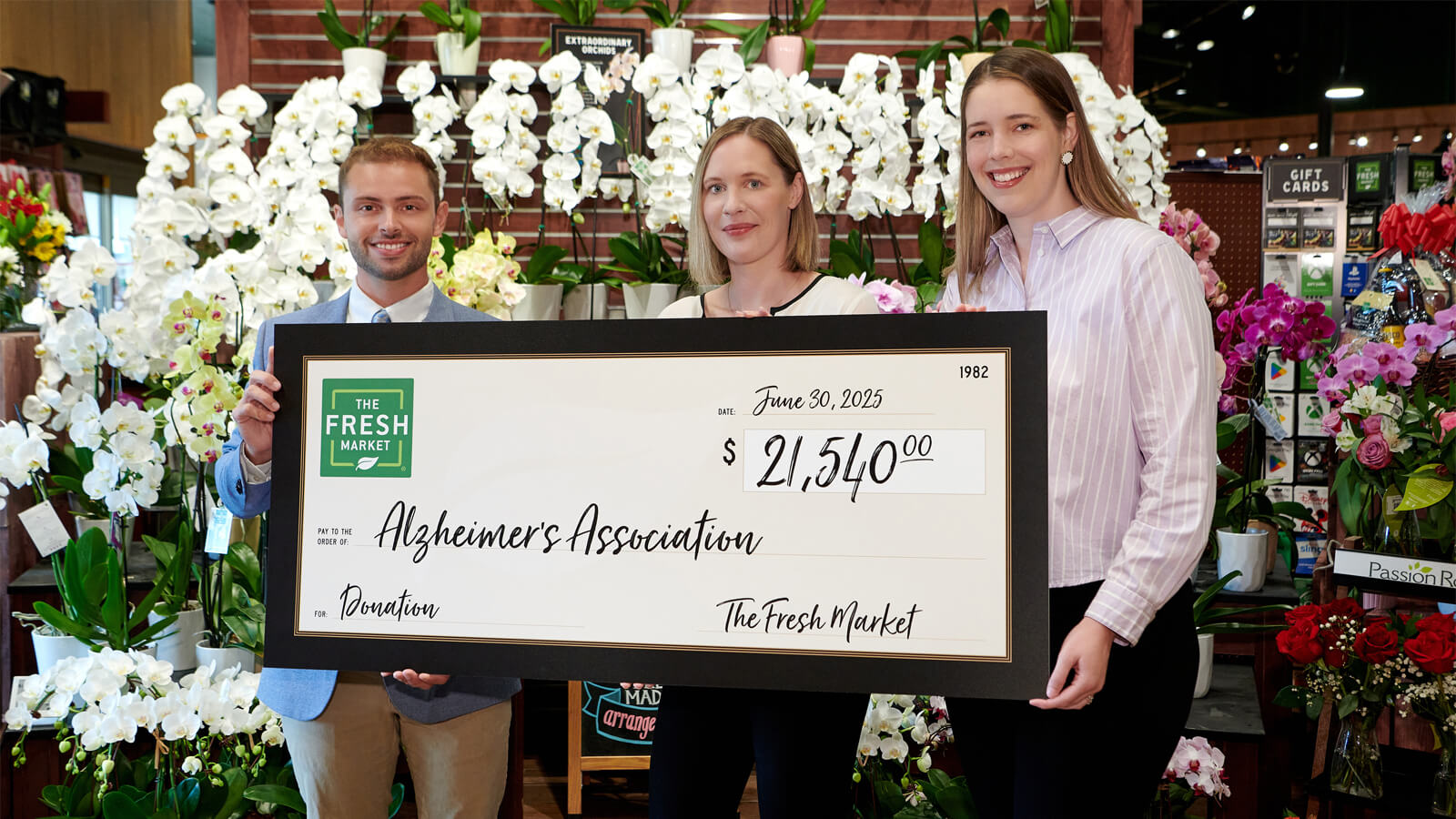 The Fresh Market present the Alzheimer's Association with donation check.