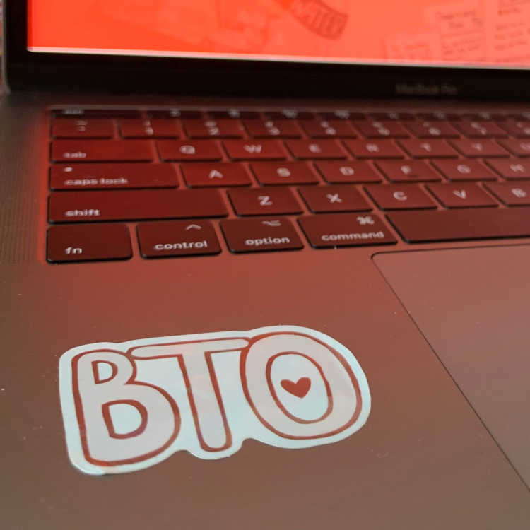 Image of BTO Bubble letter sticker, showing wider image of sticker on laptop.
