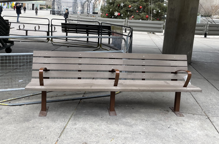 A public bench showing antihomelessness design principles