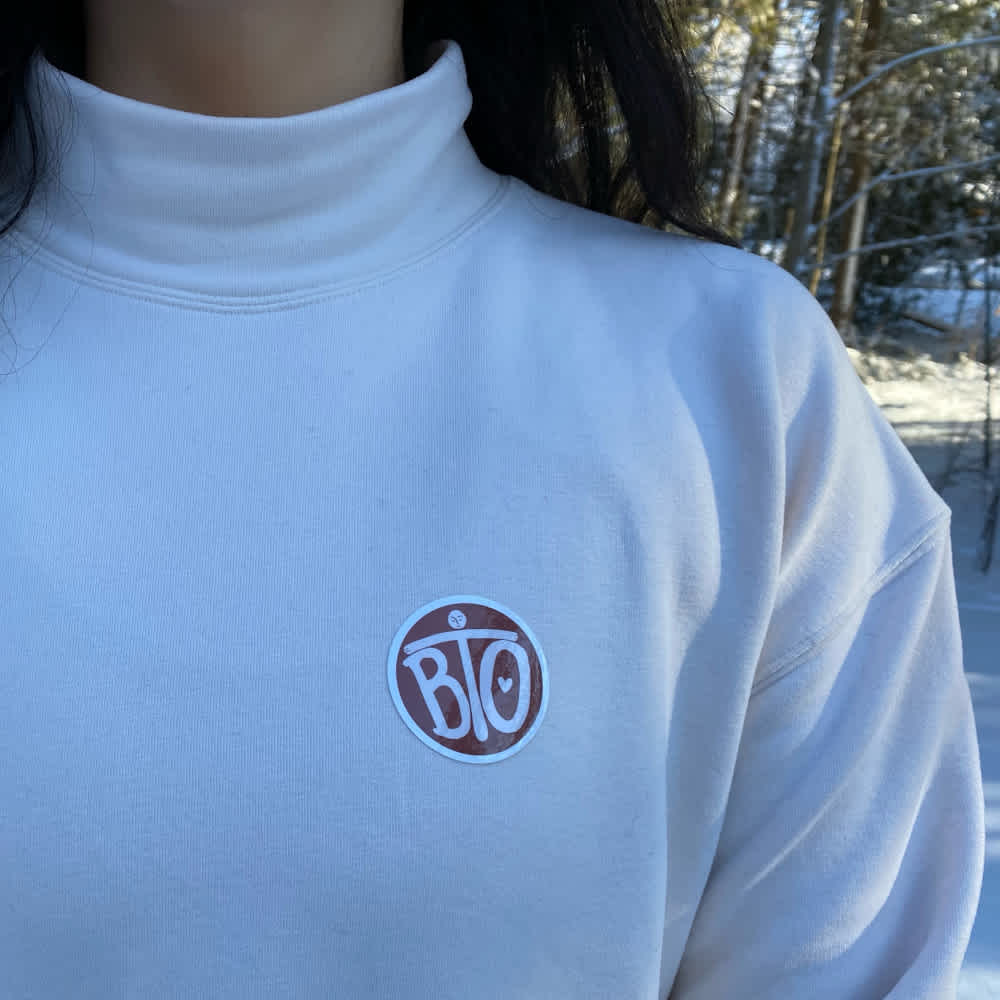 Image of Round sticker item, showing sticker on clothing.
