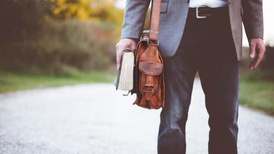 Man carrying Bible and satchel