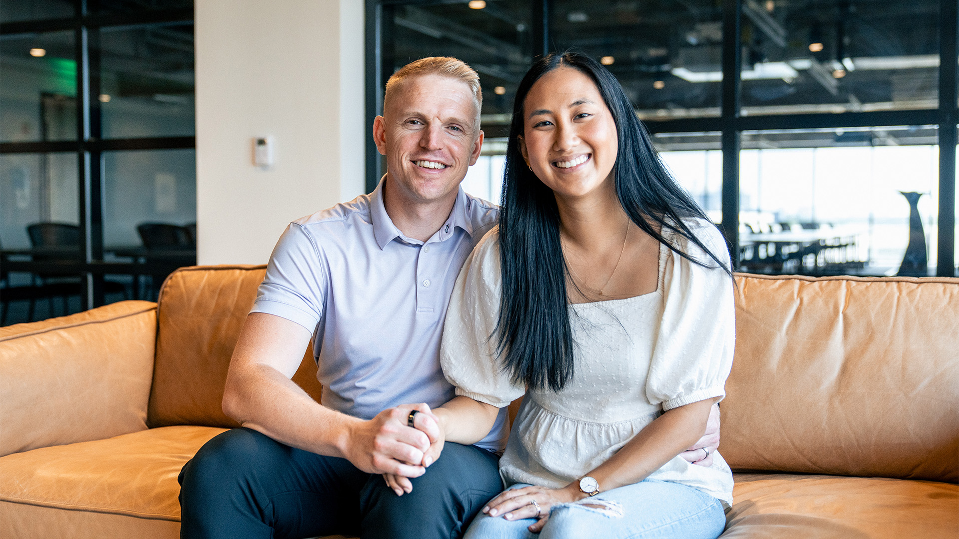 Smiling married couple sitting on a couch at Watermark Community Church in Dallas, Texas, symbolizing unity and hope during challenging seasons in Christian marriage.