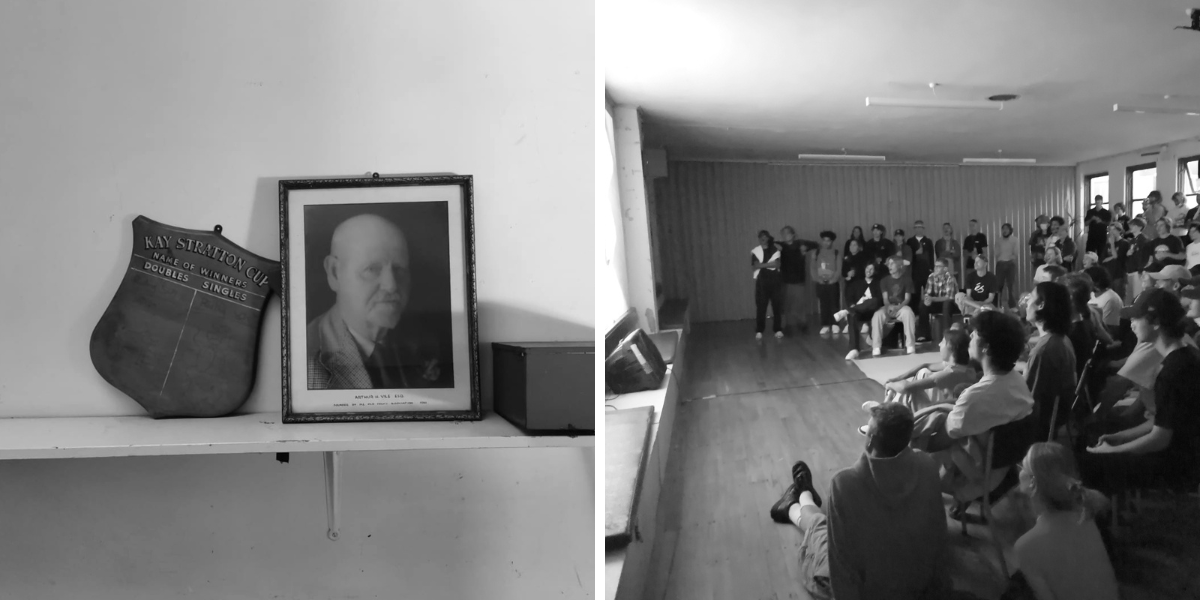 Aged photograph of elderly man on shelf alongside disused trophy. Casually-dressed teenagers sit, stand in a semi-circle.