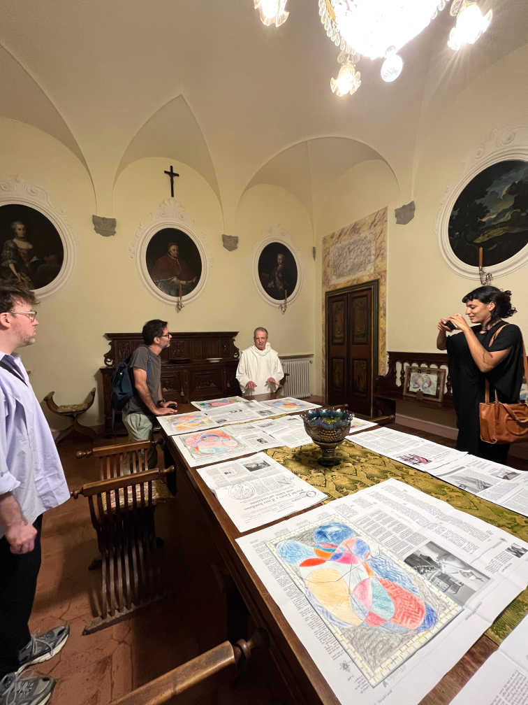 Pictured: Ugo showing the Amant Siena residents his drawings at the Abbey of Monte Oliveto Maggiore, 2023. Photograph by Sriwhana Spong