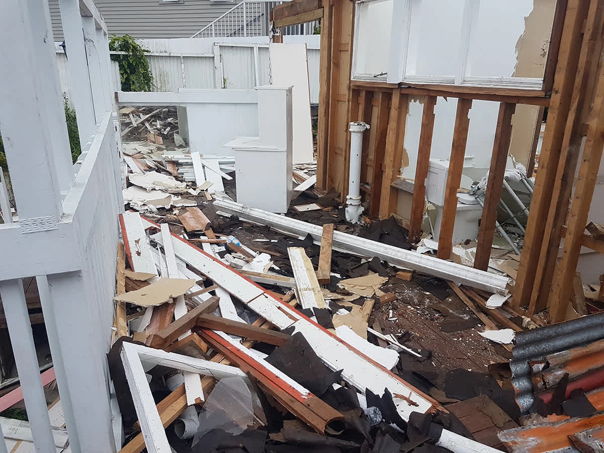 Pictured: “Debris and Ruins.” Close-up of the scattered debris at the site. The scattered rubble consists of broken wood, drywall, and other construction materials.