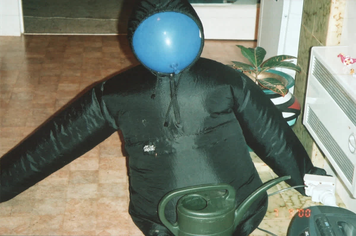 Pictured: “Prototypical Experimentation of the Wind MillionAIRe Concept: A Black Alpac Raincoat Inflated by a Central Heating Vent, Anchored by a Green Plastic Watering Can.”