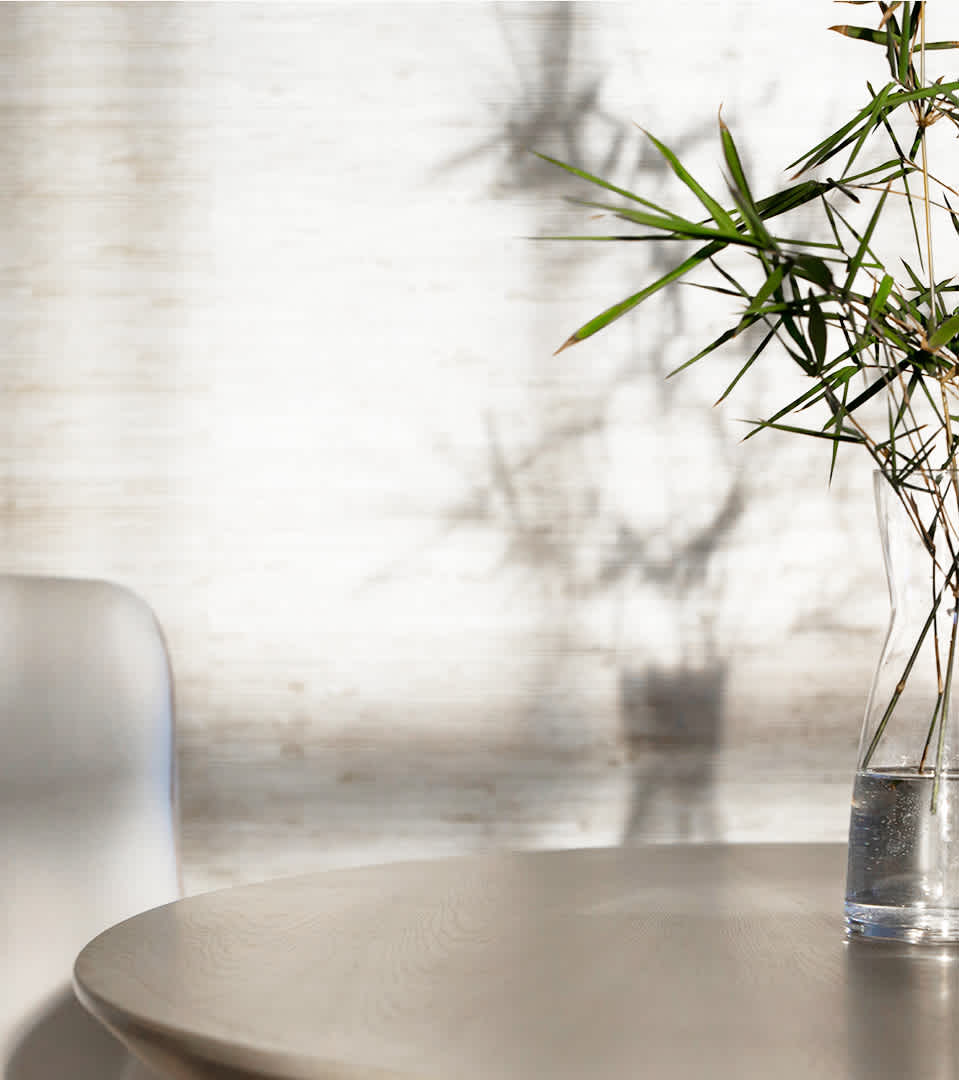 Embrace the art of mindful living with this serene image of the 'Hourglass of Intention' by Sensei, set against a backdrop of soft shadows and a bamboo plant's slender foliage. The photograph captures a tranquil corner that reflects on the importance of time and the practice of intention setting. Accompanied by a thoughtful description of the hourglass's purpose to facilitate mindfulness and focus, this image is perfect for those seeking to inspire a dedicated space for reflection, habit formation, and self-care rituals in their daily lives.