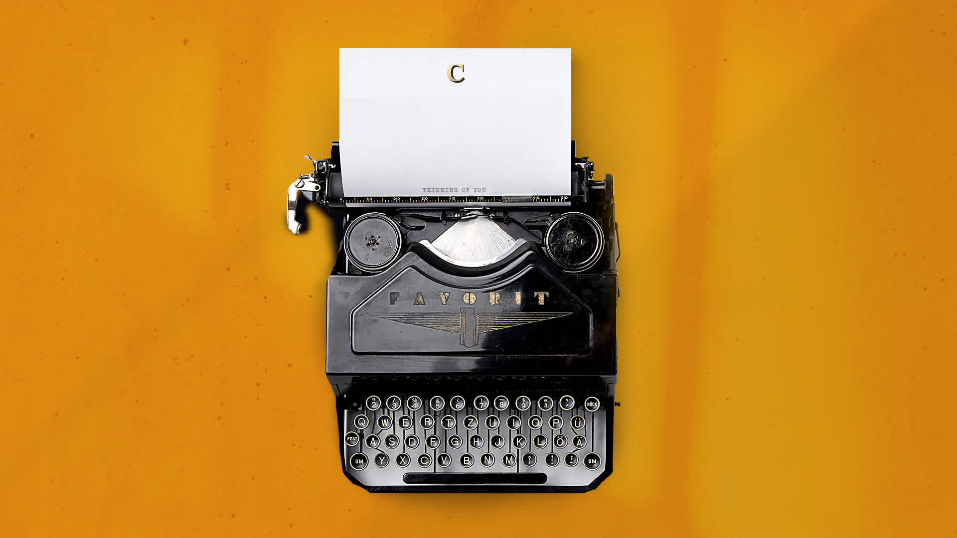 A typewriter with The Commoner logo on the paper and a yellow background with light streaks.