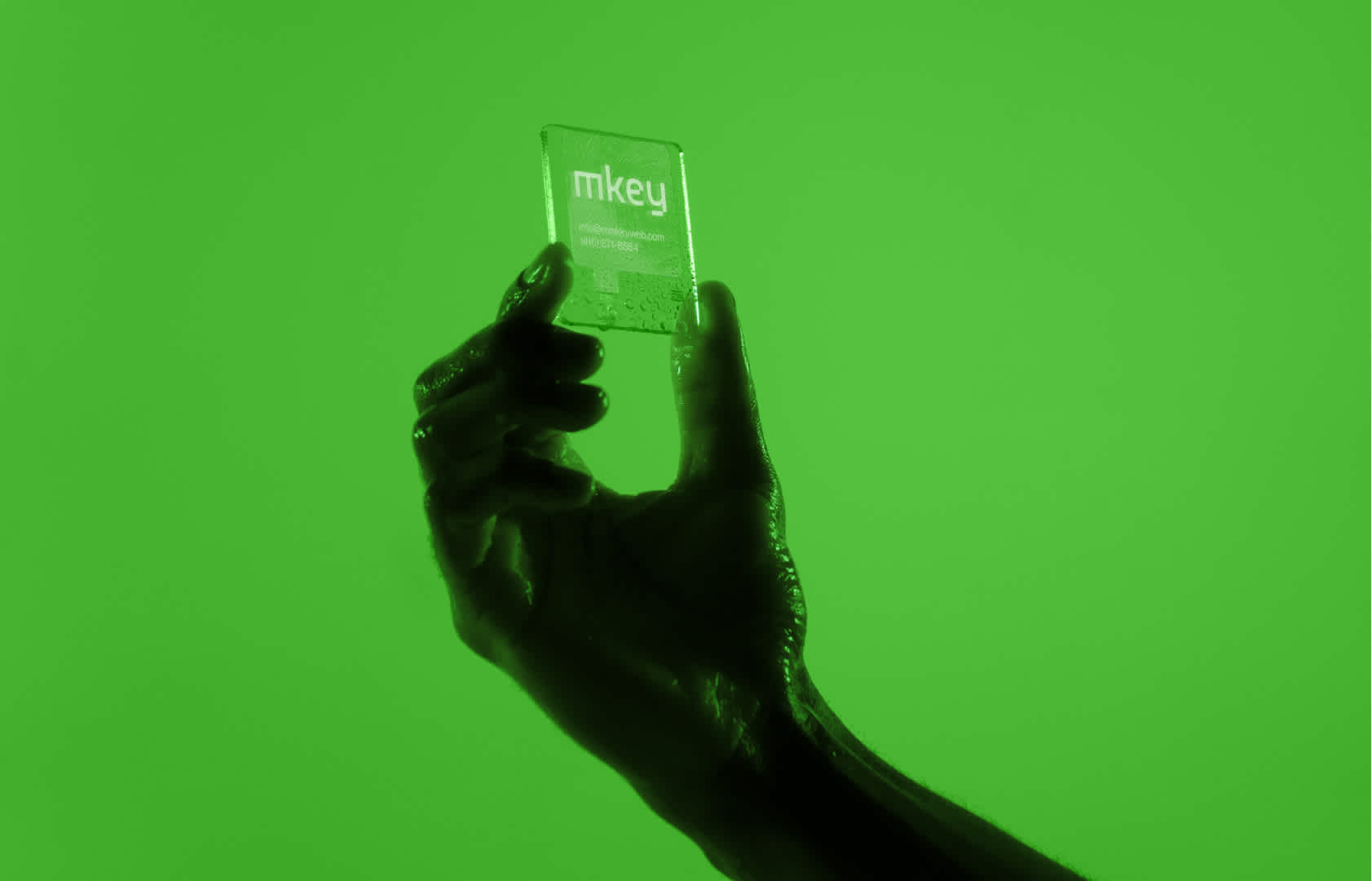 Hand holding a futuristic Business Card with the MKEY Logo