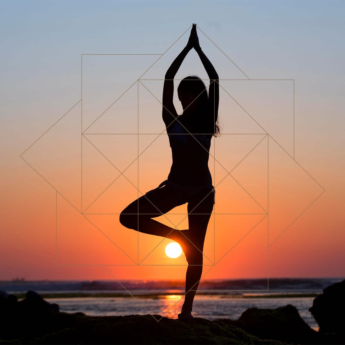 A person performing a yoga pose in front of the sun on the Four Seasons Resort Costa Rica Pura Vida Spa beach.