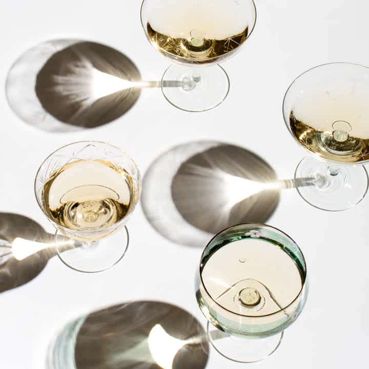 A look and feel shot of champagne glasses from above with stark light and shadows for the Paradise Banquet Halls branding case study.