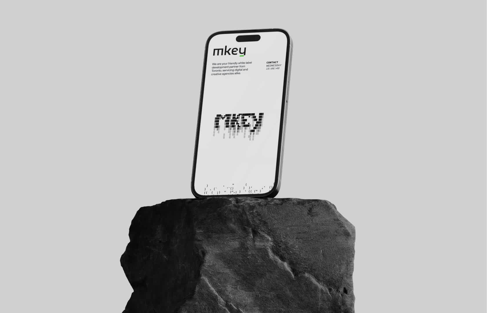 A phone showcasing the MKEY website