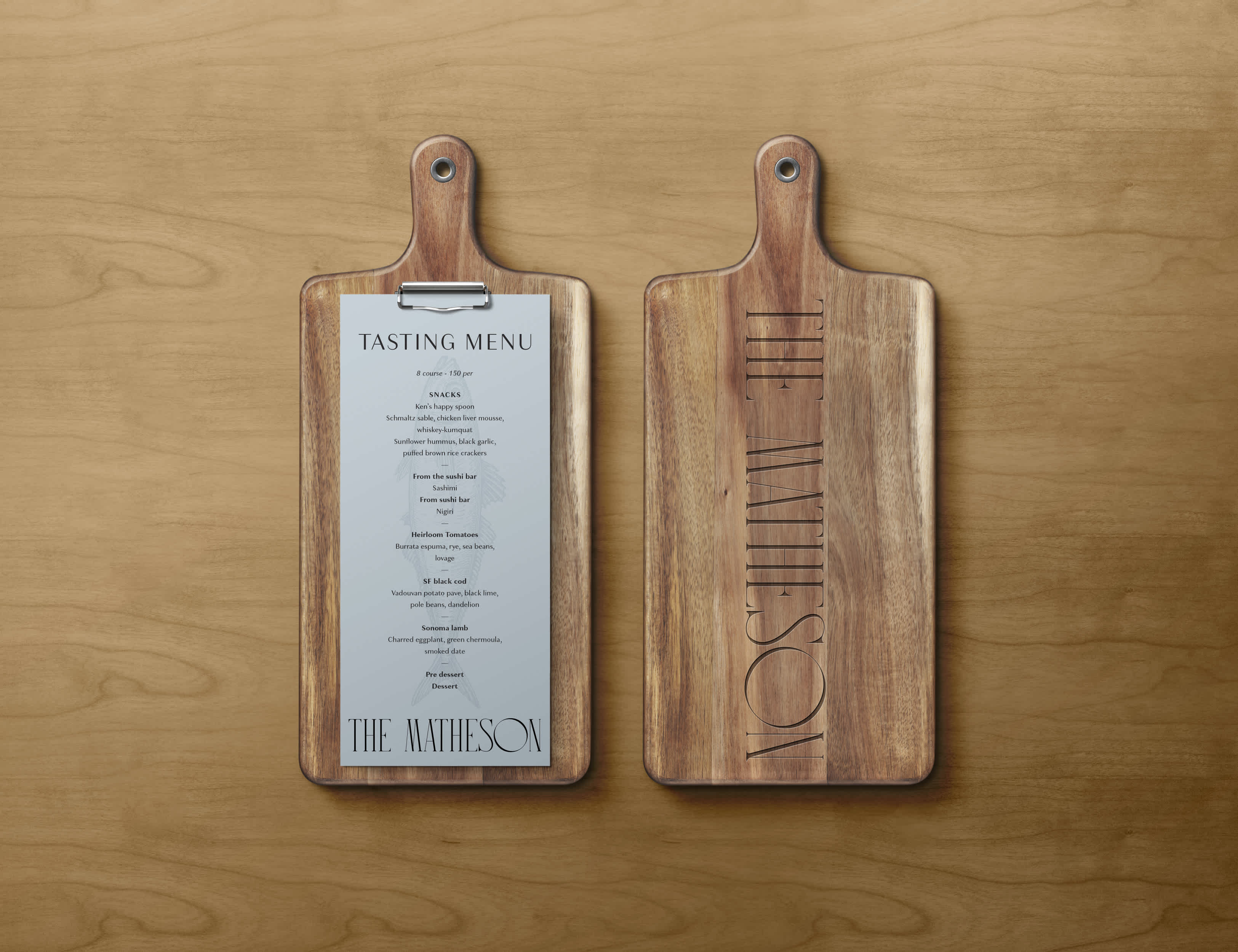 A cheese board with The Matheson tasting menu attached on the front and The Matheson logo embedded in the back.