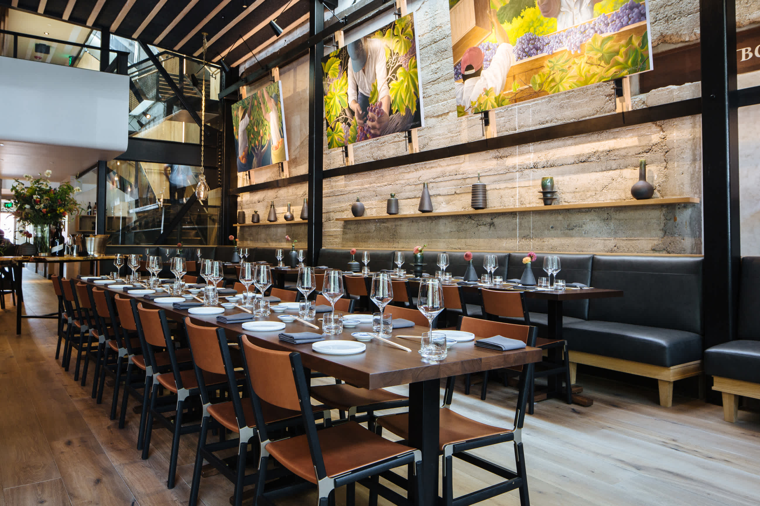 The Matheson restaurant interior with tall ceilings and a long central table with wine glasses and table settings.