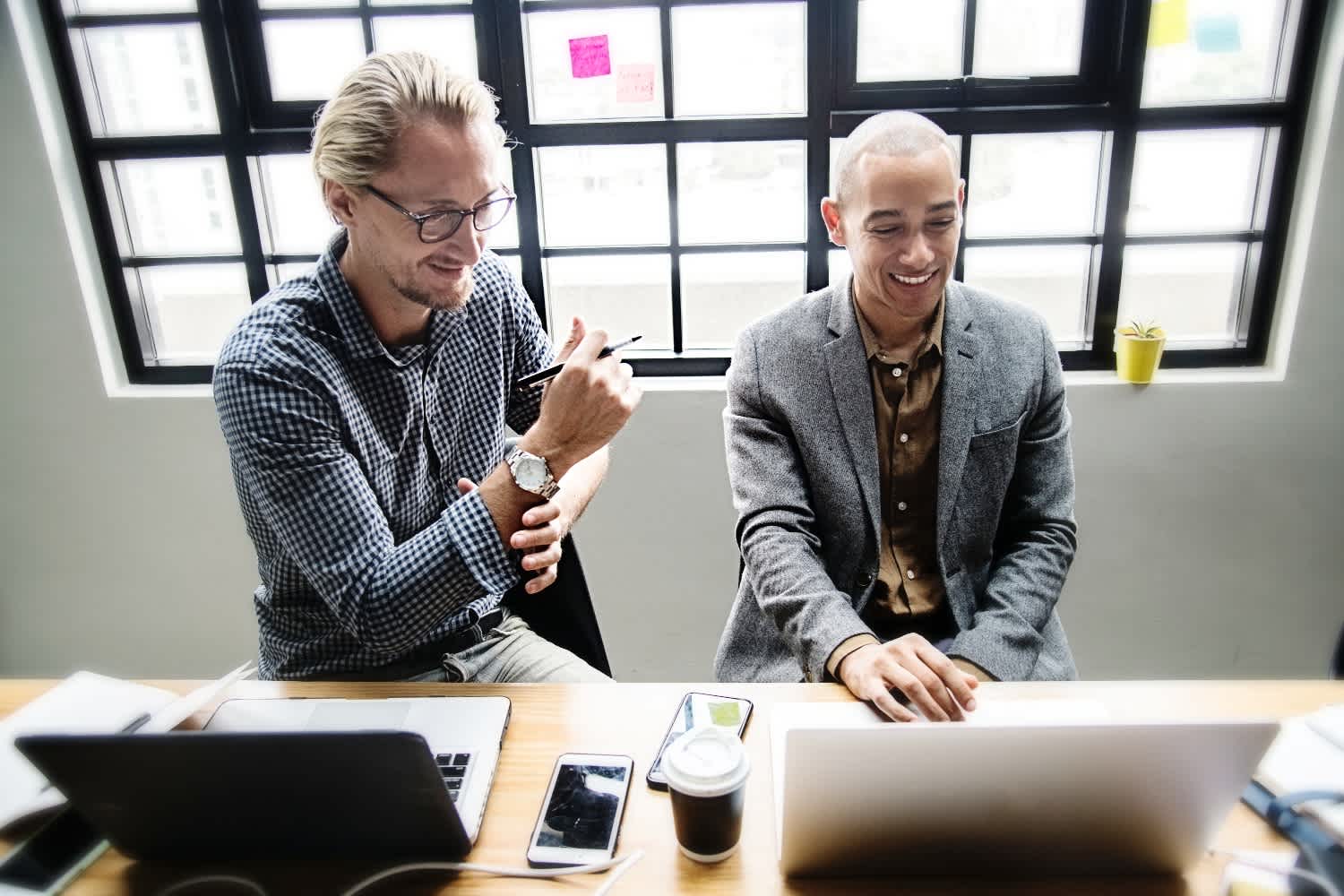 two person looking at one laptop edited