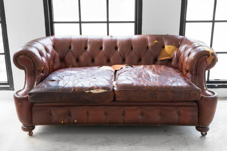 A closeup view of a worn out piece of furniture to show the life span of a sofa.