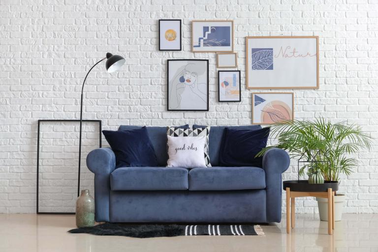 A sofa with an arrangement of wall art above it