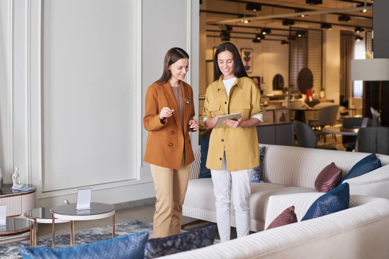 A view of a customer talking to a store employee shows the importance of an easy shopping experience for the customer as they walk through how to complete their transaction.