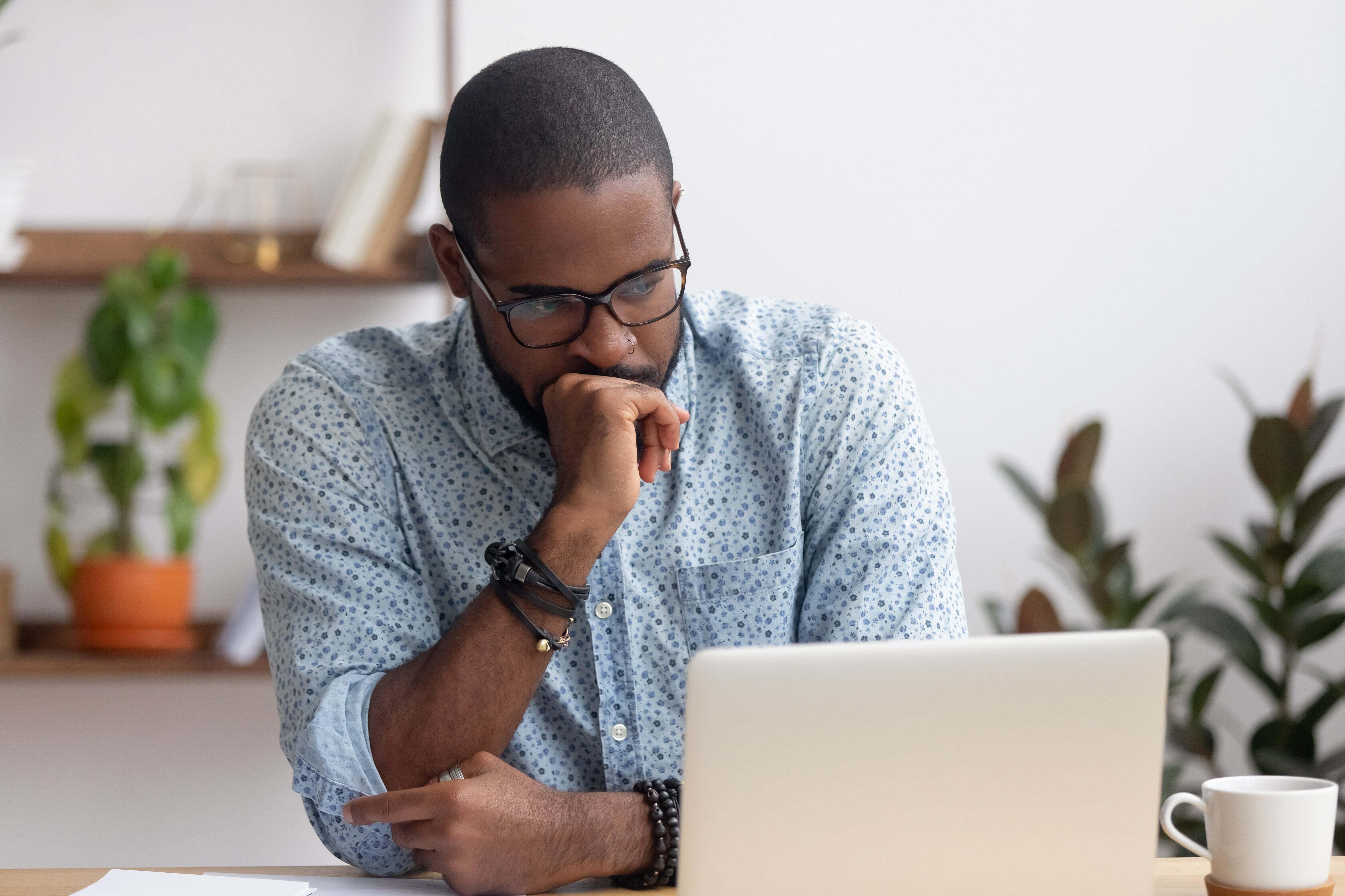 A man staring at his laptop