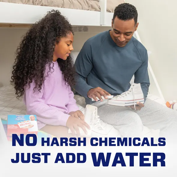 A man and a girl cleaning sneakers together, promoting Mr. Clean Magic Eraser using just water