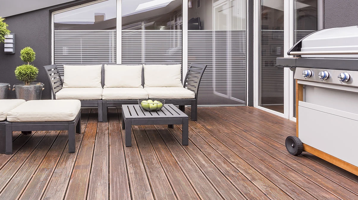 A terrace with outdoor furniture and a barbecue