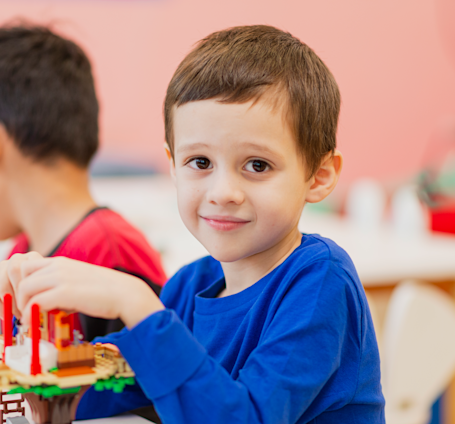 A child having fun building LEGO bricks in LEGO therapy