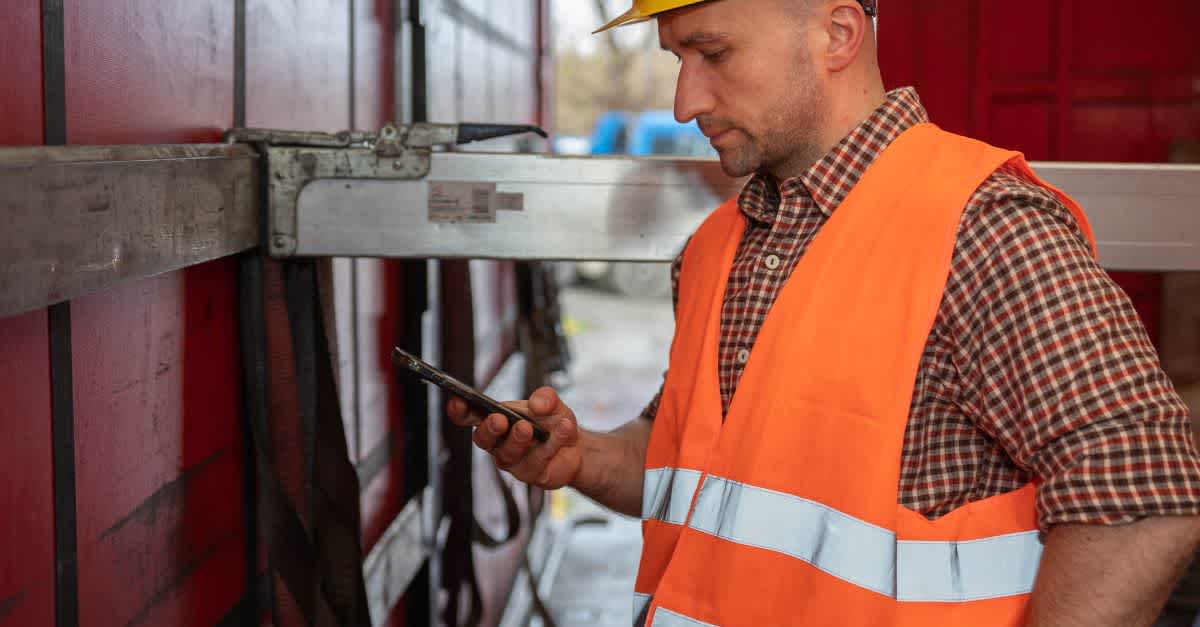 A truck owner uses a mobile assistant app at work