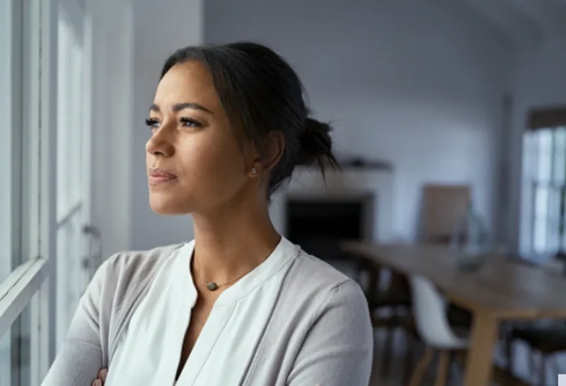 woman staring out the window