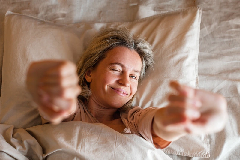 woman stretching in bed