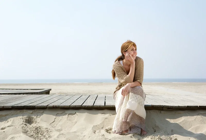 women sitting in beach
